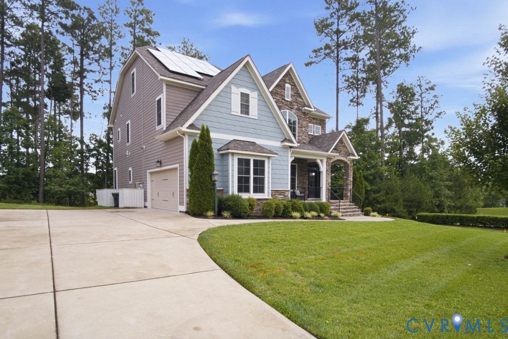 6991 Carden Park Drive, Carden Park, Moseley, VA 23120 Multi-level residence featuring a stone and siding exterior with solar panels