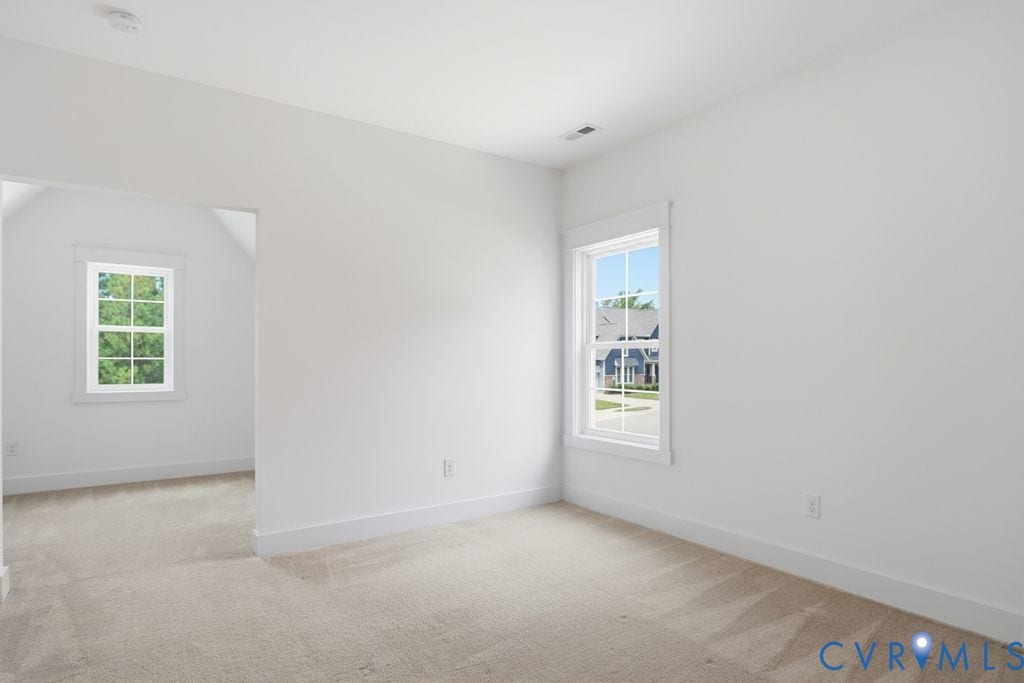 6991 Carden Park Drive, Carden Park, Moseley, VA 23120 Carpeted room featuring white walls, white trim, and two windows with white frames