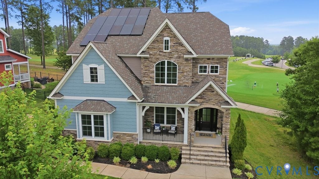 6991 Carden Park Drive, Carden Park, Moseley, VA 23120 Stone and siding exterior with a covered porch, solar panels, and arched windows