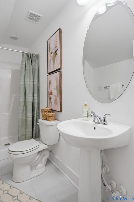 6991 Carden Park Drive, Carden Park, Moseley, VA 23120 Bathroom featuring a white pedestal sink with chrome faucet, an oval mirror, and a toilet