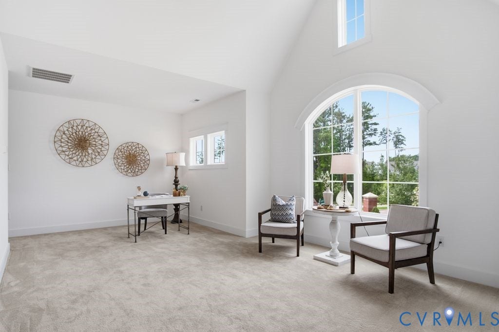 6991 Carden Park Drive, Carden Park, Moseley, VA 23120 Spacious interior featuring a vaulted ceiling and a large arched window with grid detailing
