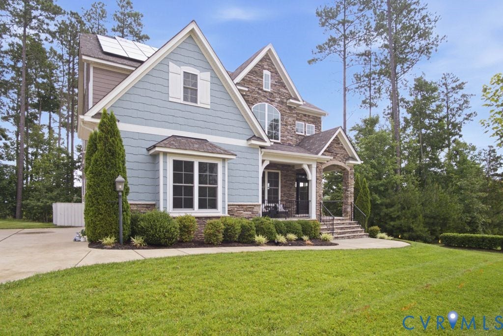 6991 Carden Park Drive, Carden Park, Moseley, VA 23120 Stone and shingle-style exterior featuring a covered entry, established landscaping, arched entryway, and multiple gables