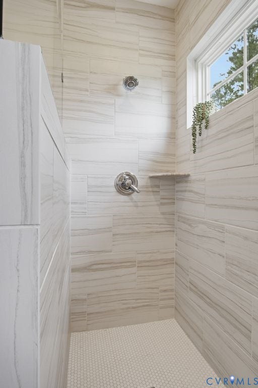 6991 Carden Park Drive, Carden Park, Moseley, VA 23120 Tile shower featuring a built-in shelf, rainfall showerhead, and a small window