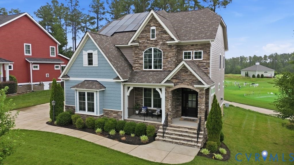 6991 Carden Park Drive, Carden Park, Moseley, VA 23120 Stone and siding exterior with a covered porch entry, arched window detailing, and solar panels