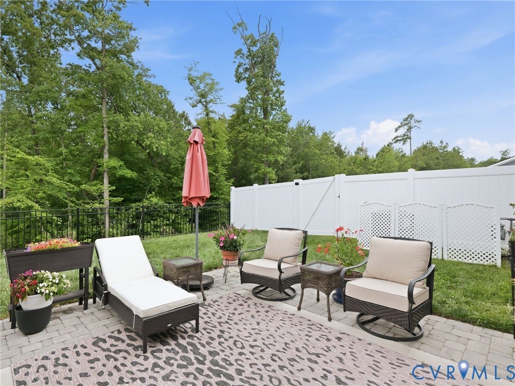 9237 Cerulean Place, Richmond, VA 23238 Enjoy the best of both worlds...screened-in comfort & open-air relaxation on this extended paver patio w/a serene wooded view. Black metal fencing added for pet containment yet not to obstruct the gorgeous lush view.