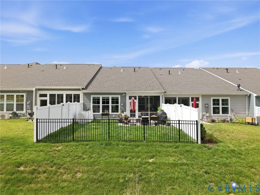 9237 Cerulean Place, Richmond, VA 23238 A perfect outdoor setup featuring a screened-in/glassed-in porch, oversized paver patio, and fenced yard, ideal for relaxing or entertaining. Fenced-in area is great for small pets to get some outdoor time or kids to play.
