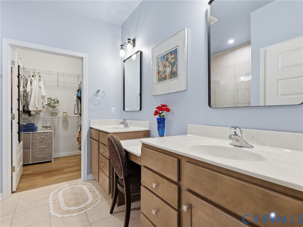 9237 Cerulean Place, Richmond, VA 23238 A refined primary bath featuring dual vanities, a sleek glass shower, and a sizable water closet for added privacy.