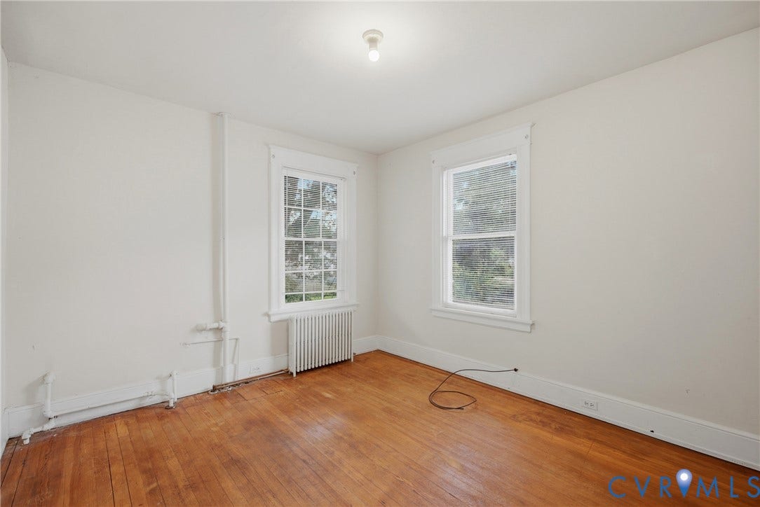 3110 North Avenue, Brookland Park, Richmond, VA 23222 Hardwood flooring, two windows with white trim, a ceiling-mounted light fixture, and white painted walls