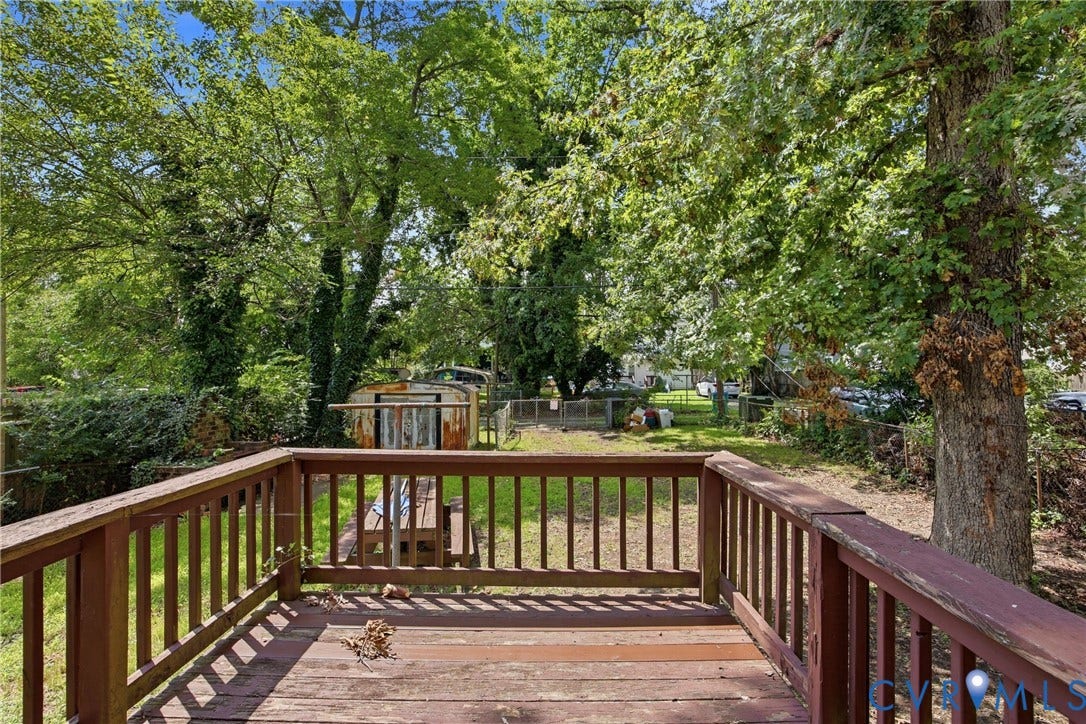 3110 North Avenue, Brookland Park, Richmond, VA 23222 Expansive composite deck with sturdy wood-finish railings overlooking a mature tree-lined landscape
