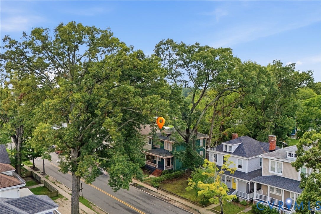 3110 North Avenue, Brookland Park, Richmond, VA 23222 Mature tree-lined street featuring classic residential architecture with varied exterior finishes, including traditional siding and pitched rooflines