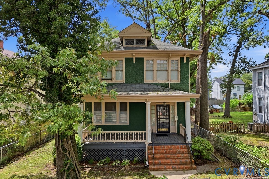 3110 North Avenue, Brookland Park, Richmond, VA 23222 Green exterior with light trim, covered porch, brick steps, a screen door, and a partially fenced yard