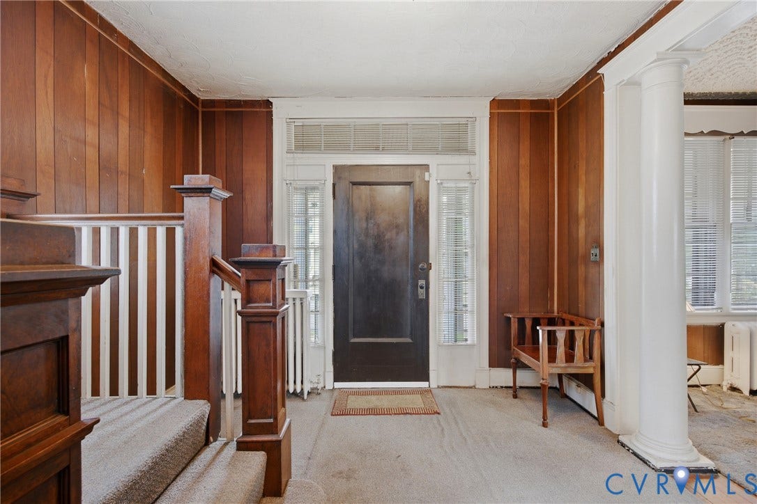 3110 North Avenue, Brookland Park, Richmond, VA 23222 Elegant foyer showcasing rich wood-finish paneling and built-in cabinetry, complemented by a black front door with sidelights and transom window