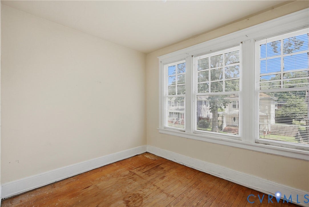 3110 North Avenue, Brookland Park, Richmond, VA 23222 Bright corner bedroom with abundant natural light from multi-pane windows, warm wood-finish flooring, and crisp white trim throughout