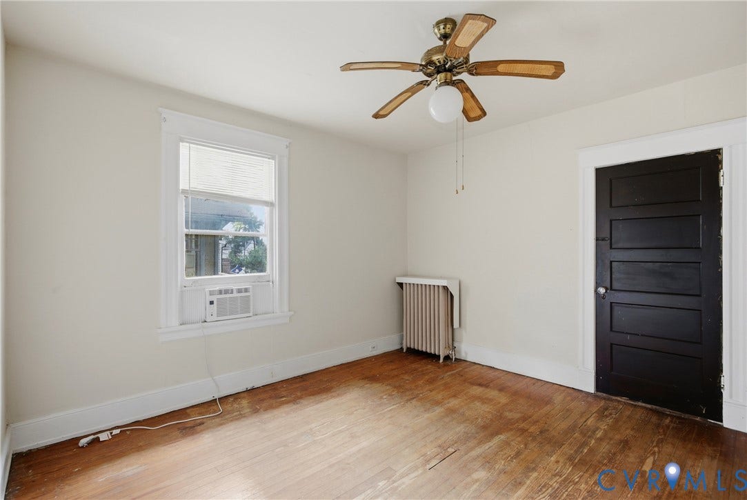 3110 North Avenue, Brookland Park, Richmond, VA 23222 Wood-finish flooring, paneled door, built-in window air conditioning unit, ceiling fan with light fixture, and radiator