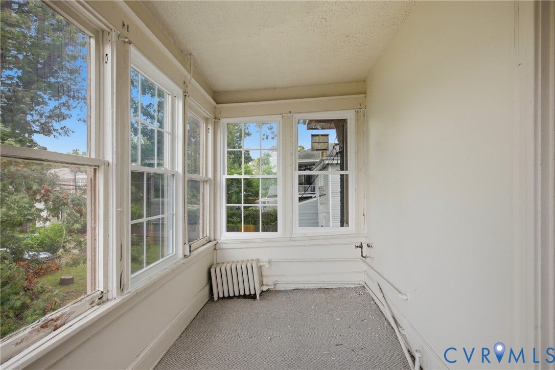 3110 North Avenue, Brookland Park, Richmond, VA 23222 Enclosed porch with multiple pane windows, white painted trim, and radiator heating