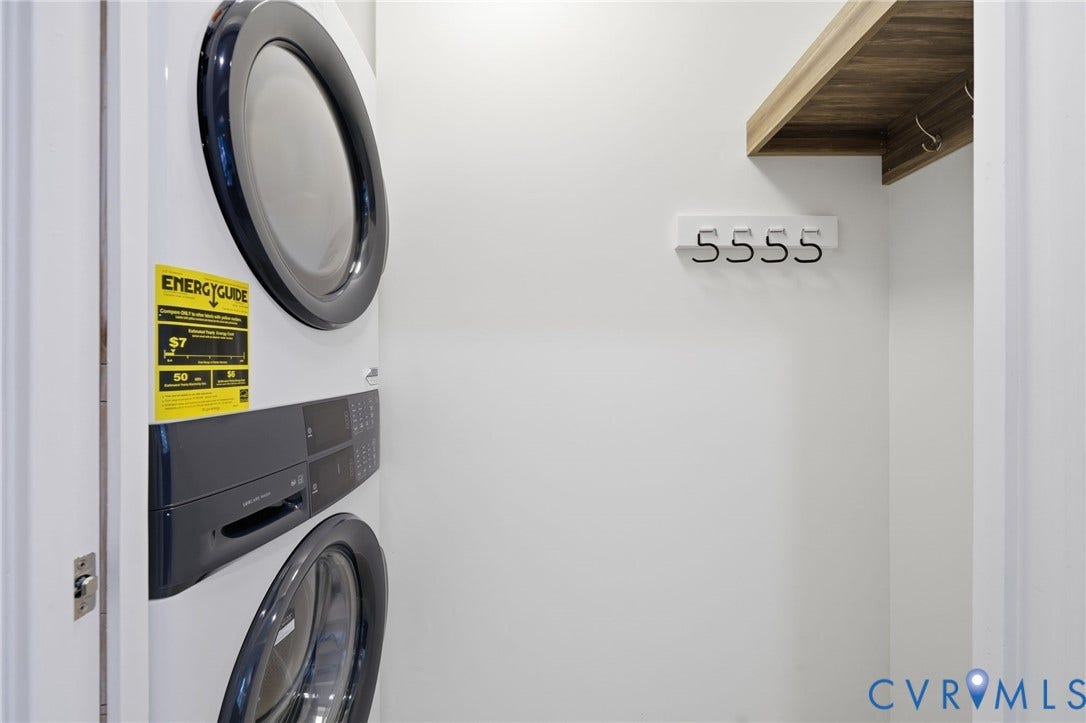 2919 Grayland Avenue, Byrd Park/ Carytown, Richmond, VA 23221 Dedicated laundry area featuring a stacked washer and dryer unit, overhead wood-finish shelving, and a wall-mounted coat rack