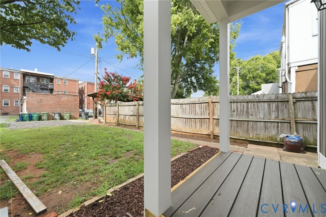 2919 Grayland Avenue, Byrd Park/ Carytown, Richmond, VA 23221 Rear porch featuring gray composite decking, white support columns, and a landscaped border