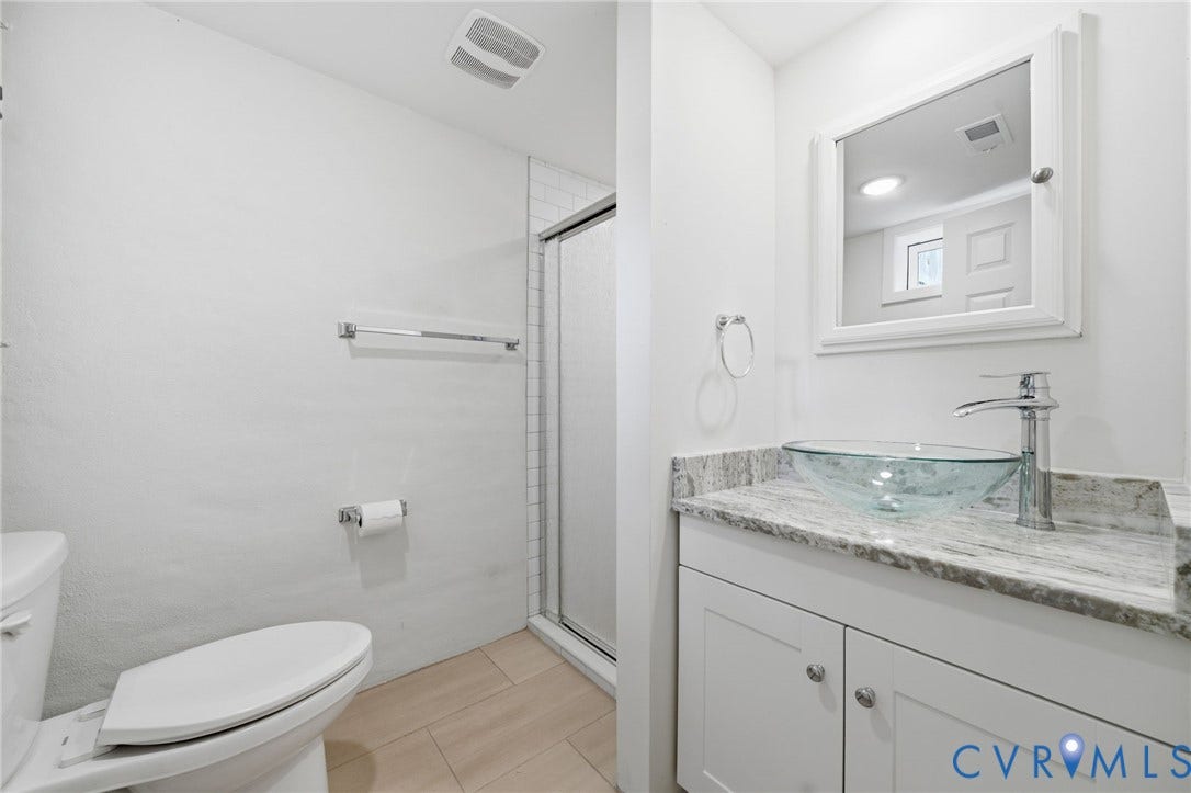 2919 Grayland Avenue, Byrd Park/ Carytown, Richmond, VA 23221 Full Bathroom in basement with vanity featuring a glass vessel sink, chrome faucet, and stone countertop
