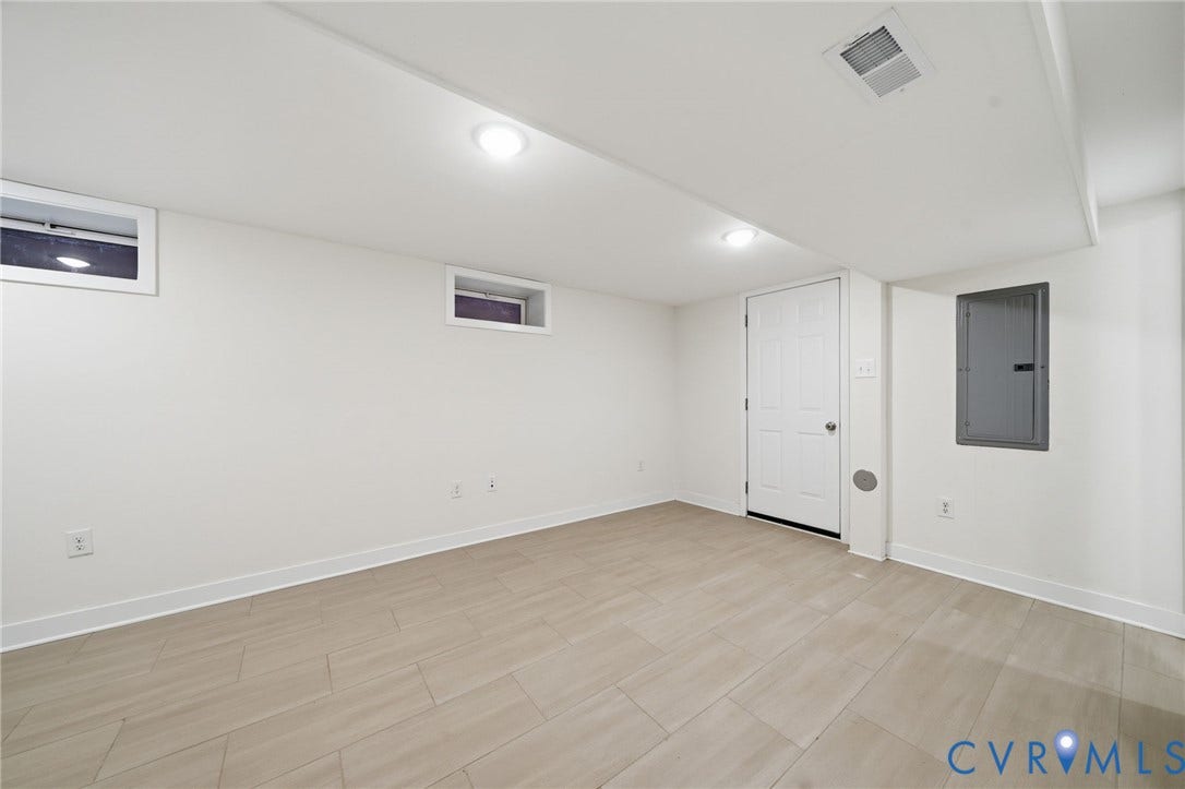 2919 Grayland Avenue, Byrd Park/ Carytown, Richmond, VA 23221 Finished lower level room featuring light-toned tile flooring, recessed ceiling lighting, two small windows, and a panel door