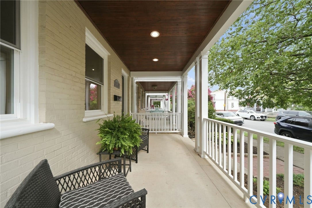 2919 Grayland Avenue, Byrd Park/ Carytown, Richmond, VA 23221 Covered front porch featuring a wood-panel ceiling with recessed lighting, white columns and railings, and a light-colored brick exterior