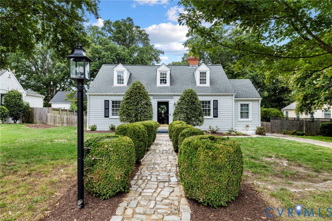 1002 Normandy Drive, Henrico, VA 23229 Siding exterior with three dormer windows, black shutters, and a brick chimney