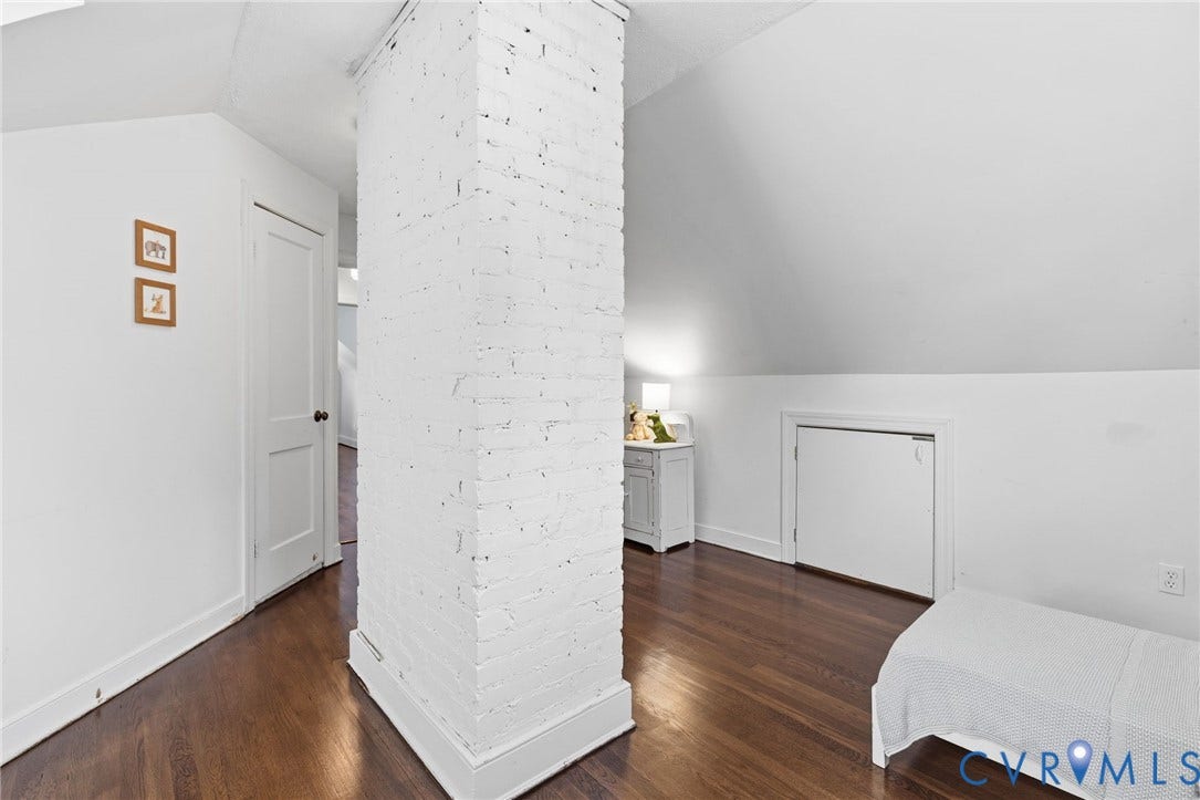 1002 Normandy Drive, Henrico, VA 23229 Hardwood flooring, painted brick column, white walls, angled ceiling, built-in storage access