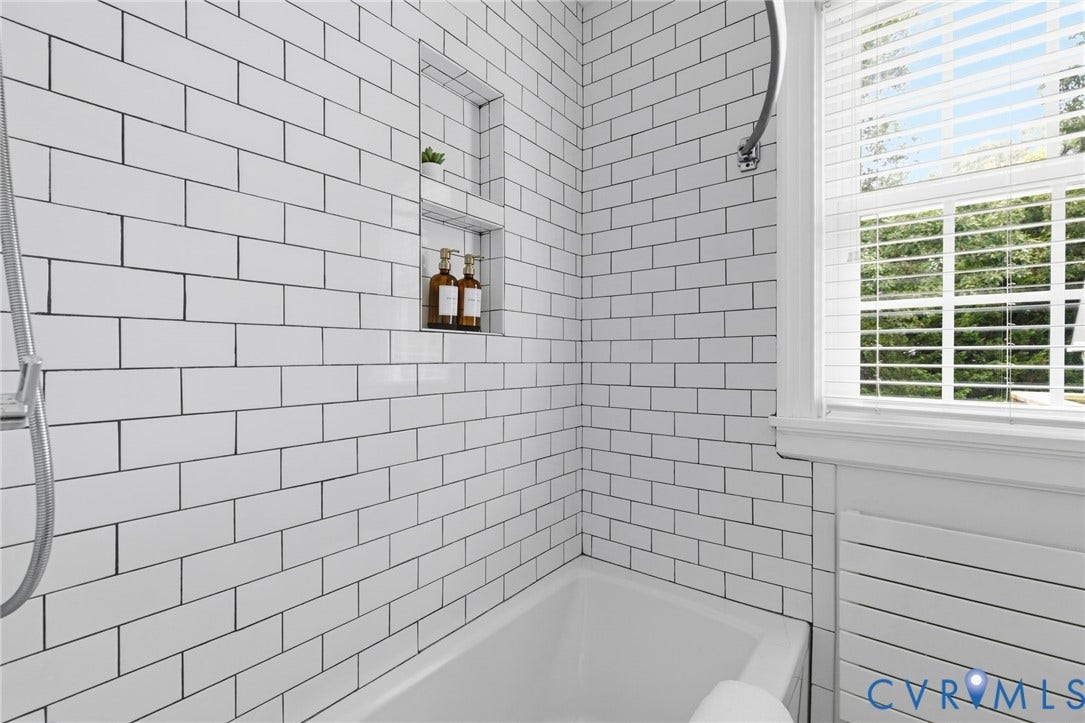 1002 Normandy Drive, Henrico, VA 23229 White subway tile surround, built-in shower niche, and a white soaking tub