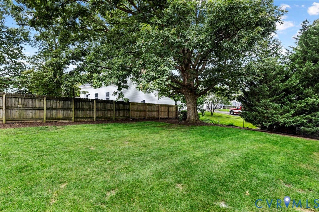 1002 Normandy Drive, Henrico, VA 23229 Expansive lawn with mature trees and a wood privacy fence