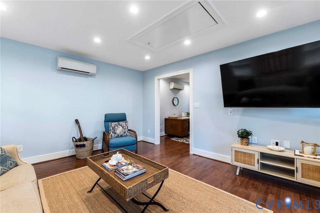 1002 Normandy Drive, Henrico, VA 23229 Rich wood-finish flooring, recessed lighting, wall-mounted display, and a split-system climate control unit