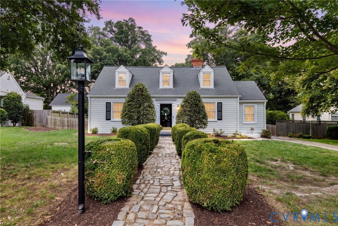 1002 Normandy Drive, Henrico, VA 23229 Light-colored siding exterior with dark shutters, multiple dormer windows, and a prominent brick chimney