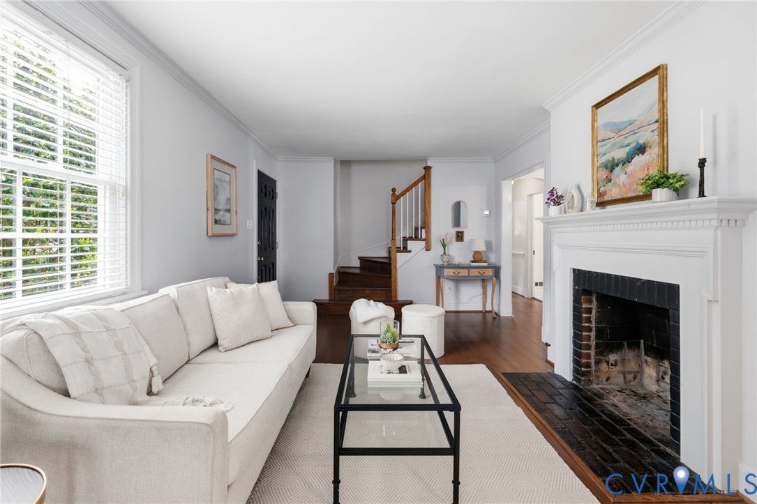 1002 Normandy Drive, Henrico, VA 23229 Hardwood flooring, painted white walls, white window blinds, white fireplace mantel, and a brick fireplace surround