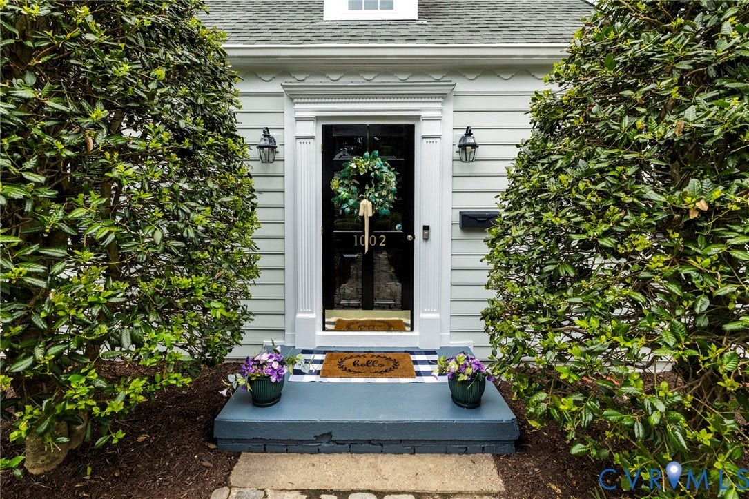 1002 Normandy Drive, Henrico, VA 23229 Charming entrance featuring a black lacquered front door with sidelights, topped with a festive wreath and lantern sconces