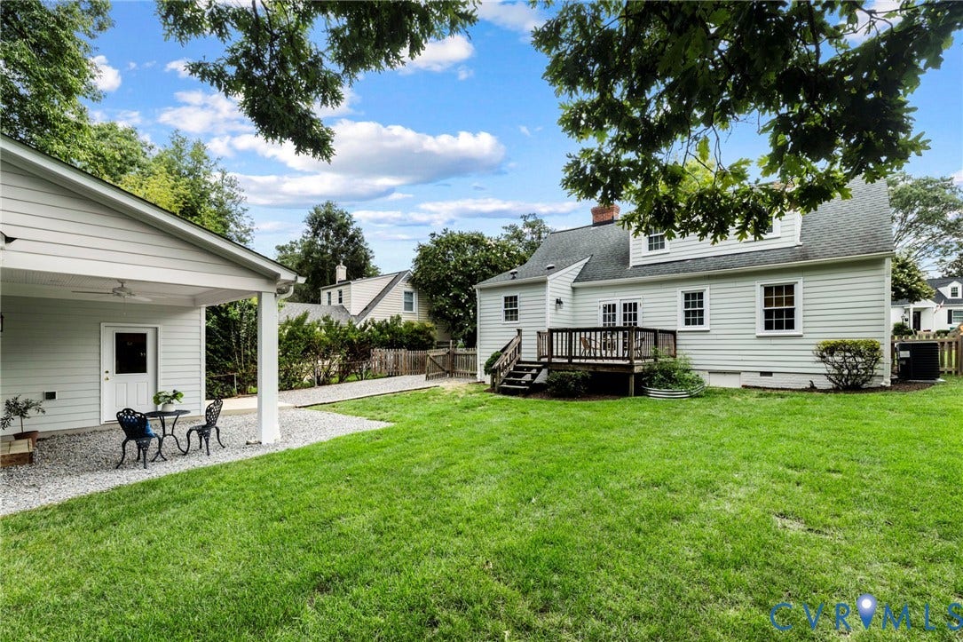 1002 Normandy Drive, Henrico, VA 23229 Expansive green lawn, a covered patio with a ceiling fan, a gravel patio area, and a wooden deck