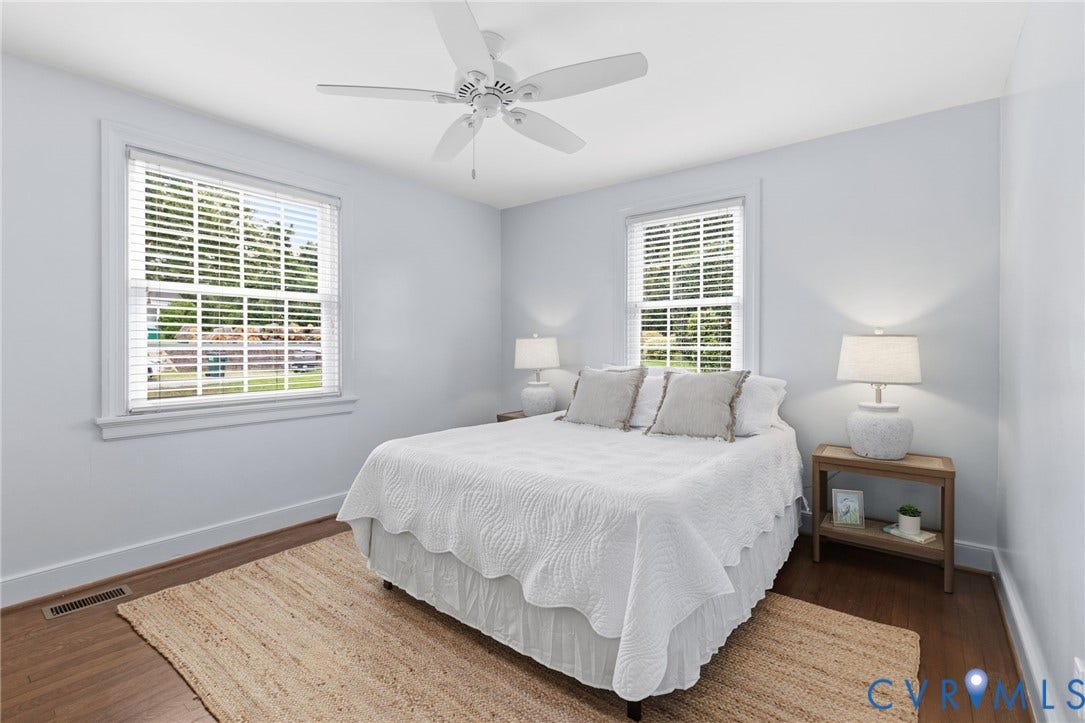 1002 Normandy Drive, Henrico, VA 23229 Wood-finish flooring, white ceiling fan, and two large windows with blinds