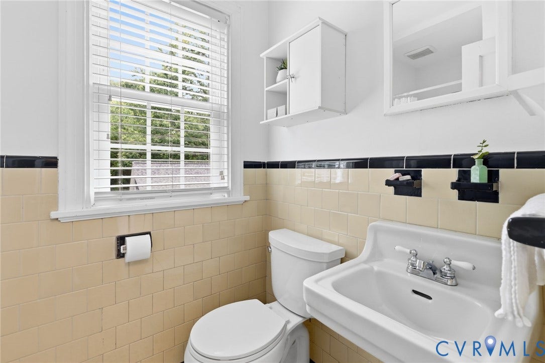 1002 Normandy Drive, Henrico, VA 23229 Neutral-toned tiled walls with a black accent border