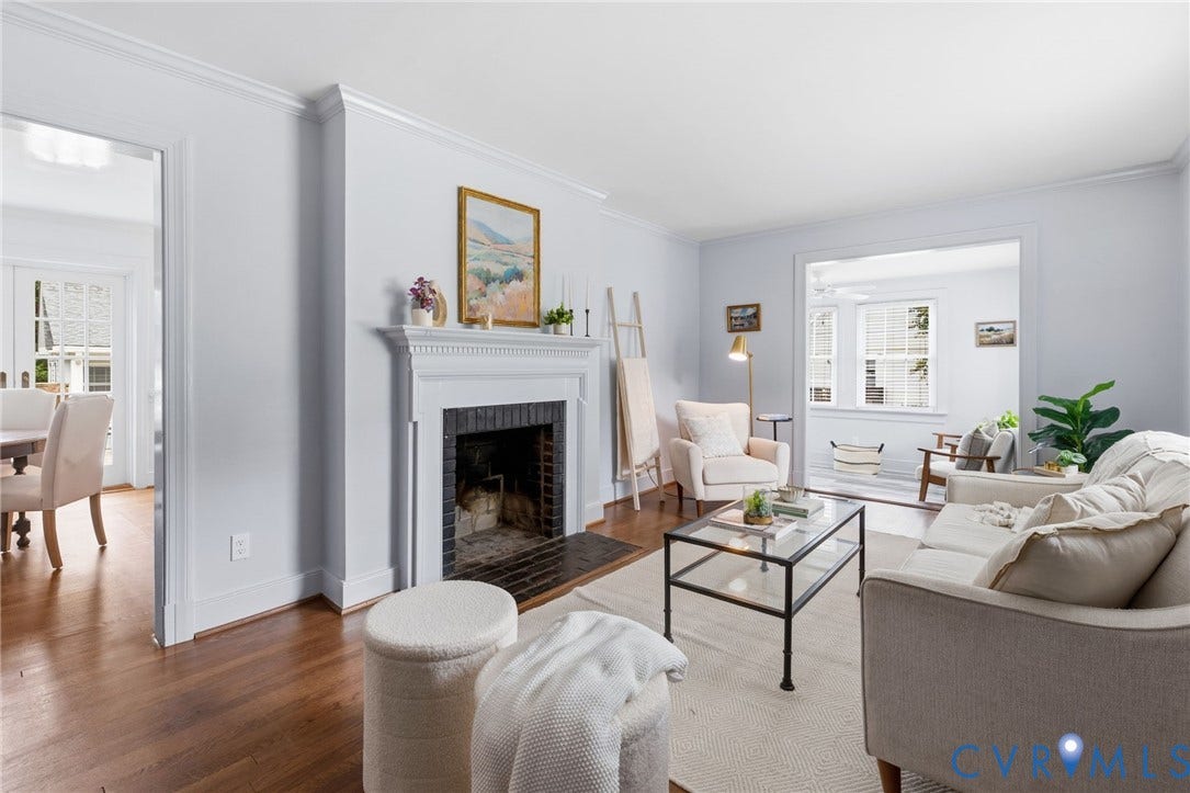 1002 Normandy Drive, Henrico, VA 23229 Hardwood flooring, crown molding, a fireplace with a white mantel, and generous natural light from multiple windows