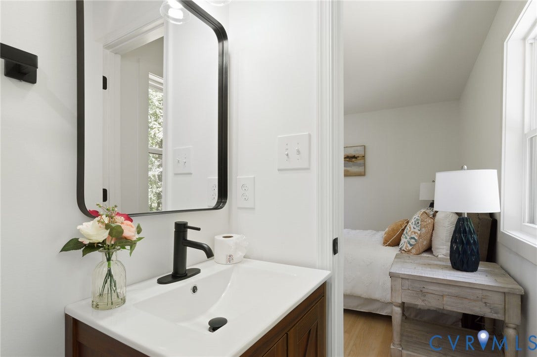 3056 Davis Mill Road, Goochland, VA 23063 Bathroom vanity featuring a white rectangular sink, matte black faucet, framed mirror, and wood-finish cabinetry
