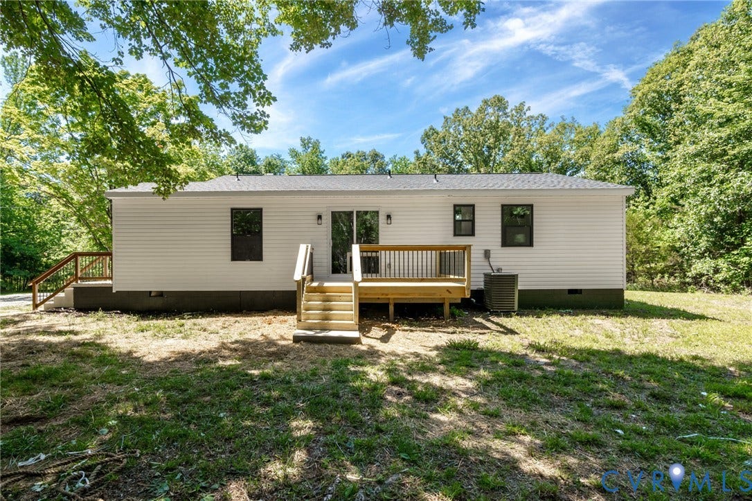 3056 Davis Mill Road, Goochland, VA 23063 Rear exterior featuring white vinyl siding, a dark shingle roof, and multiple windows with dark trim