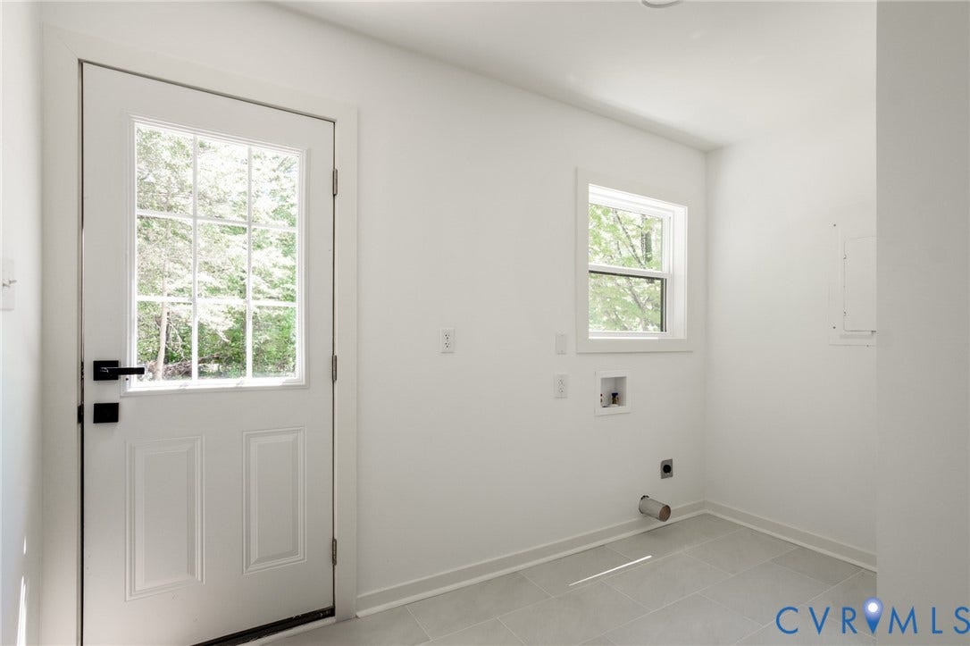 3056 Davis Mill Road, Goochland, VA 23063 Utility room featuring a white paneled door with divided lite glass, a white framed window, and light gray tile flooring