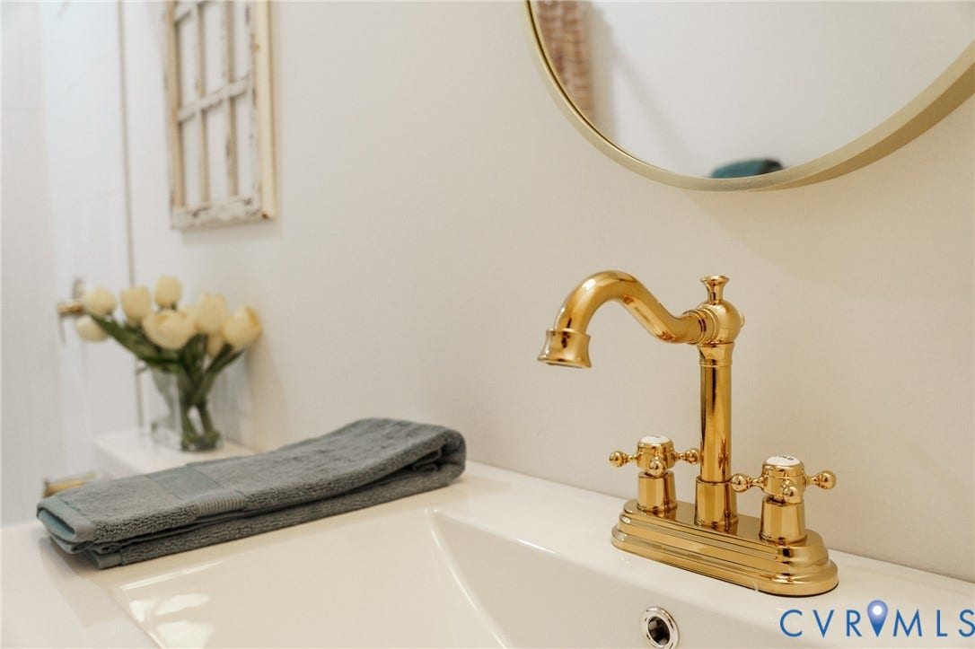 3056 Davis Mill Road, Goochland, VA 23063 Polished brass faucet with white handles, set into a white sink with an integrated countertop