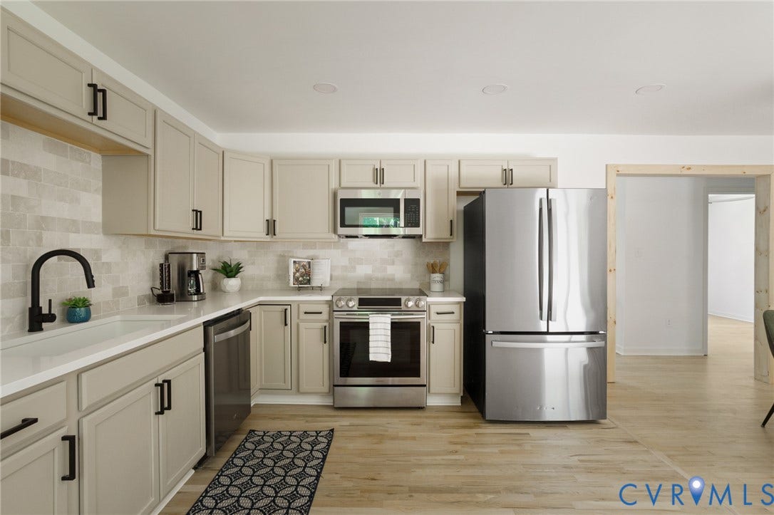 3056 Davis Mill Road, Goochland, VA 23063 Contemporary kitchen featuring light wood-finish flooring, recessed lighting, and an open doorway