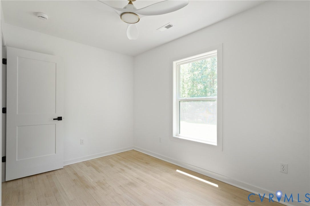 3056 Davis Mill Road, Goochland, VA 23063 Neutral interior featuring light wood-finish flooring, a contemporary ceiling fan, and a single window with exterior views