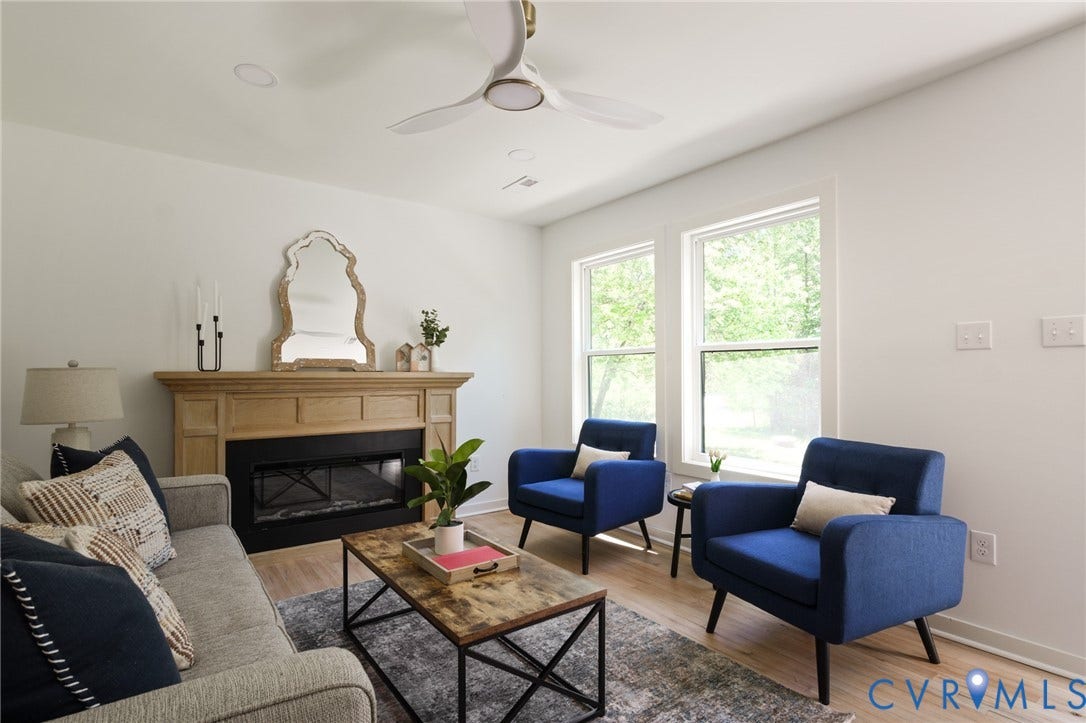 3056 Davis Mill Road, Goochland, VA 23063 Living area featuring light wood-finish flooring, a built-in fireplace with a natural wood mantel, recessed lighting, and a ceiling fan with integrated illumination