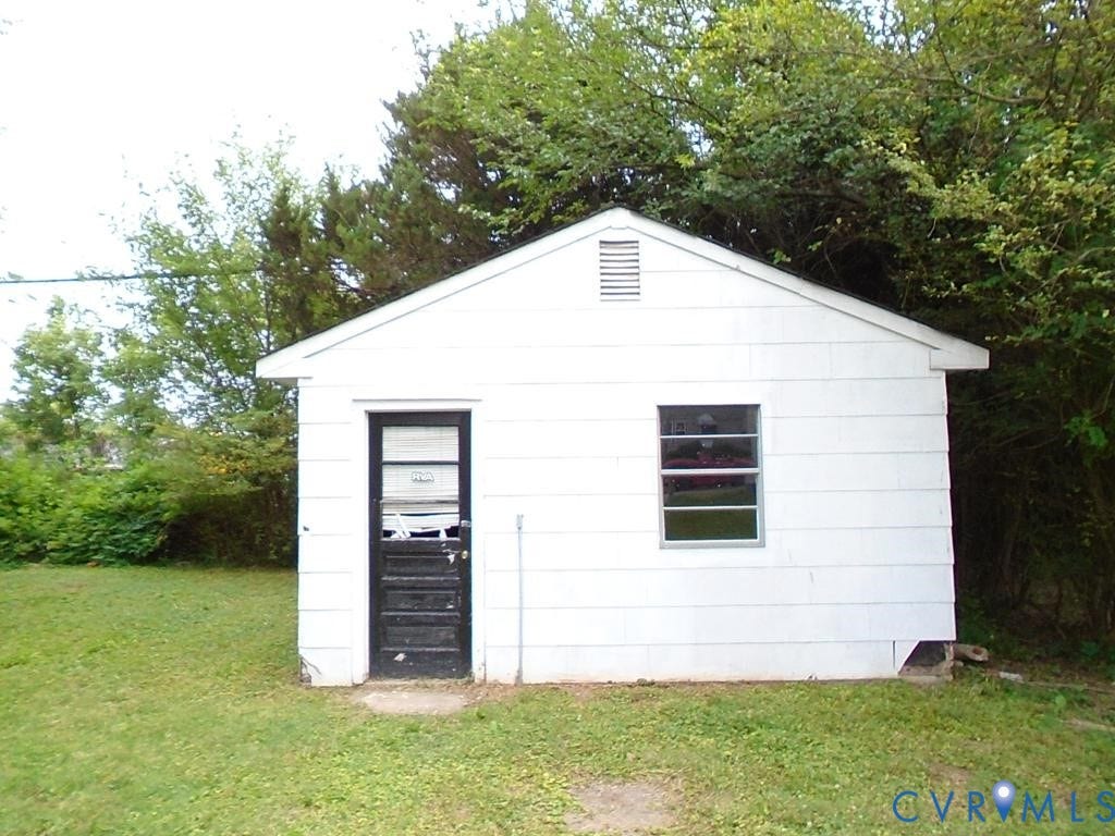 3406 Mike Road, Richmond, VA 23234 White outbuilding featuring a black entry door, a single window, and a gable roof with a vent