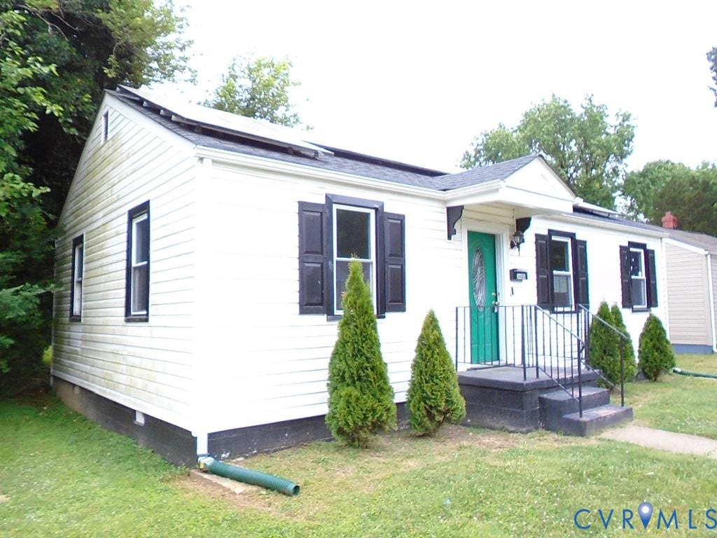 3406 Mike Road, Richmond, VA 23234 White siding exterior with black shutters and a vibrant green front door