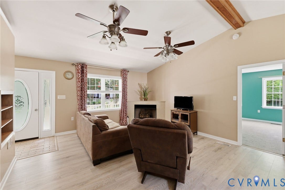 1375 Gills Road, Powhatan, VA 23139 Living room/family room with new flooring, gas corner fireplace, cathedral ceiling.