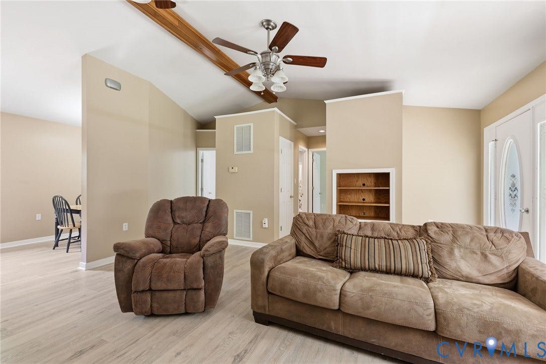 1375 Gills Road, Powhatan, VA 23139 Living room/family room with new flooring, gas corner fireplace, cathedral ceiling.