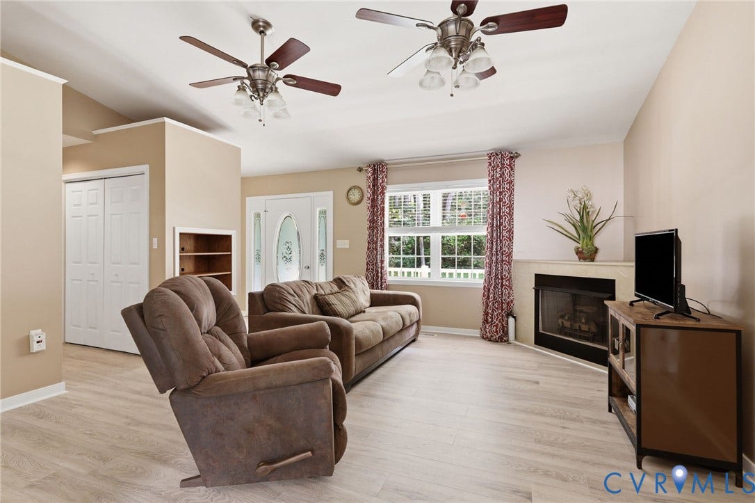 1375 Gills Road, Powhatan, VA 23139 Living room/family room with new flooring, gas corner fireplace, cathedral ceiling.