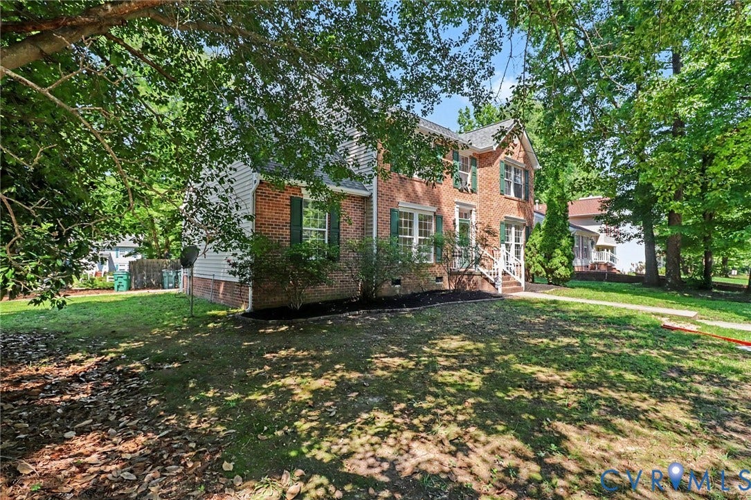 931 Hunters Run Drive, Henrico, VA 23223 Brick and siding exterior featuring a covered entry porch with white railings, multiple windows with green shutters, and established landscaping