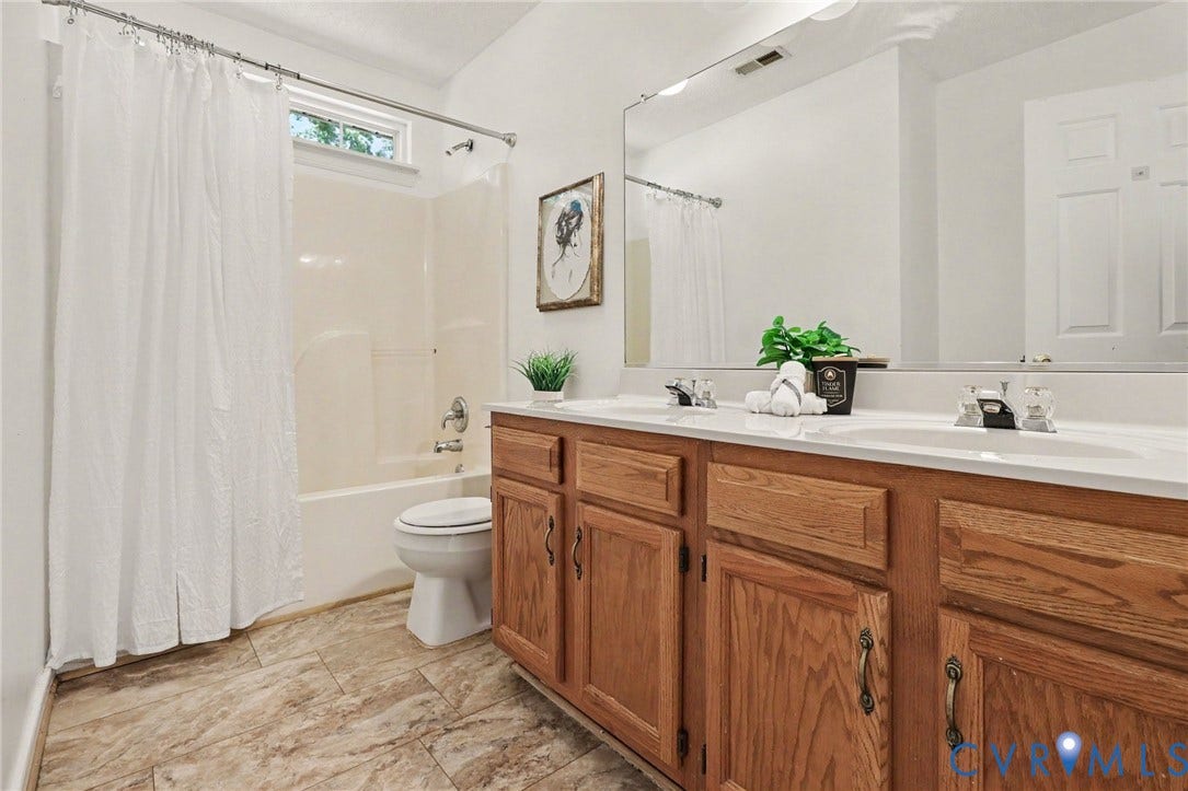 931 Hunters Run Drive, Henrico, VA 23223 Bathroom featuring a double vanity with wood cabinetry, a built-in mirror, and a shower-tub combination